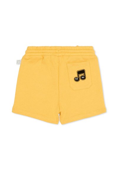 Shorts jaune pour enfants avec taille élastique et poche arrière ornée d'un graphique de note de musique noire avec des yeux.
