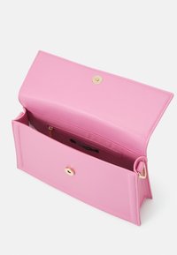 Pink faux leather handbag with a gold snap closure, rectangular shape, and a smooth texture; interior includes a zip pocket.