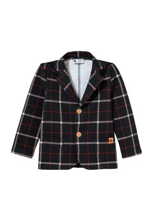 Czarno-biała marynarka w kratę z czerwonymi liniami, dwoma drewnianymi guzikami, dwoma przednimi kieszeniami i małą beżową naszywką z logo na dolnej prawej kieszeni.