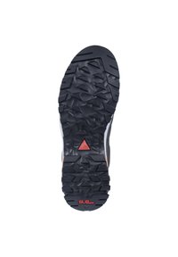 Schwarze Gummisohle mit tiefen Profil, ausgestattet mit einem roten, dreieckigen Akzent und strukturiertem Design für Grip und Haltbarkeit.