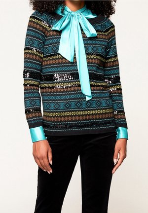 Multicolored knit sweater featuring a geometric pattern, black base, and turquoise satin collar with a bow. Sequins add texture and shine.