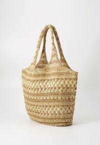 Woven straw tote bag in beige with two handles, featuring a textured pattern of horizontal and open weaves, offering a spacious compartment.