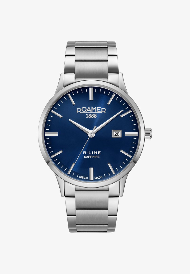 Reloj de acero inoxidable plateado con esfera azul, marcadores de hora plateados, fecha en tres en punto y cristal de zafiro. Modelo R-Line.