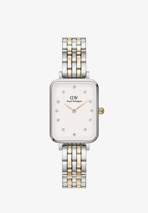 Obdélníkový kovový hodinky s bílým ciferníkem. Odkazový náramek v stříbrném a zlatém tónu. K funkcím patří křišťálové indexy a korunka na straně.