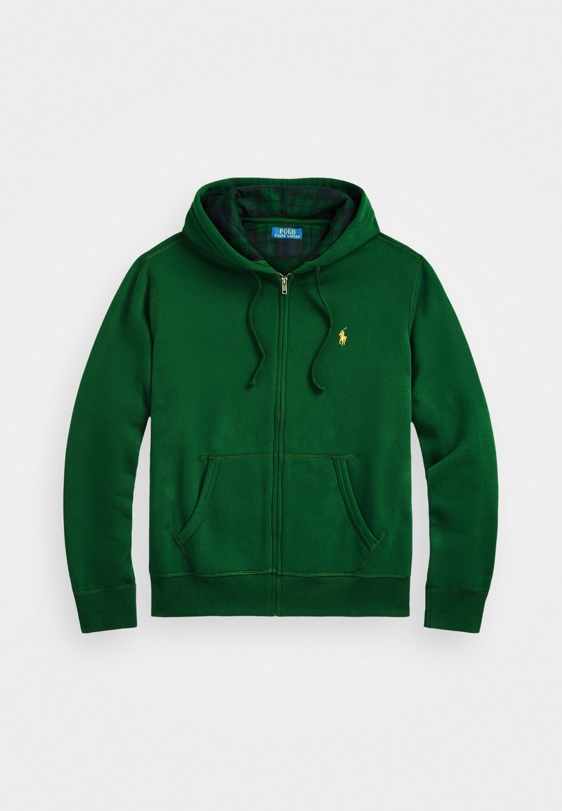 Grön zip-up hoodie gjord av mjukt material, med en framficka, snörning i huvan och en liten broderad logotyp på bröstet.