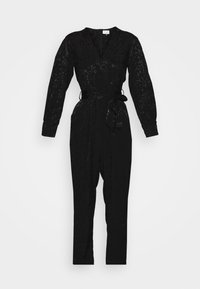 Svart jumpsuit med långa ärmar, åtsittande midja och en knytbelte. Texturerad tyg med blommönster. Dragkedjestängning bak.