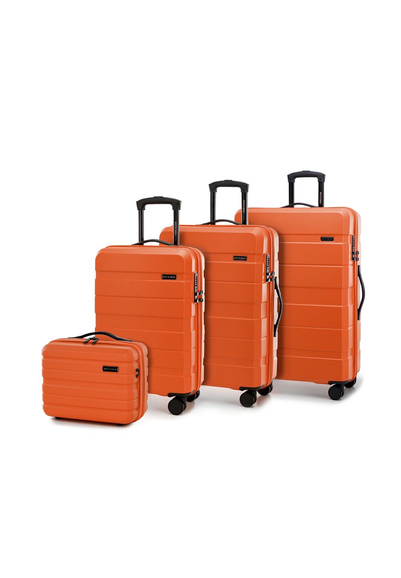 Four orange hard-shell suitcases of varying sizes. Each features a ribbed design, retractable handles, smooth-rolling wheels, and black accents.