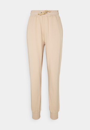 Beige sweatpants med snøre i taljen. Lavet af blødt stof, med ribbede manchetter og en afslappet pasform. Glat tekstur uden mønstre.