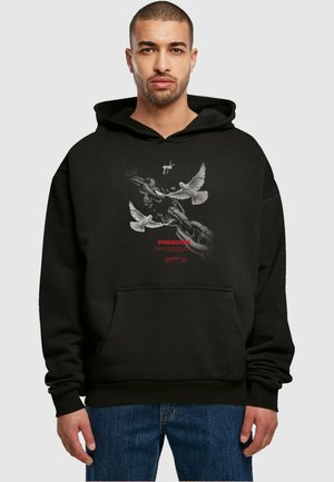 Black hooded sweatshirt featuring a graphic of doves and chains. Text reads "FREEDOM" in red. Classic fit with a front pocket.