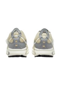 Light grey and cream athletic shoes featuring a textured upper, padded collar, and a contrasting rubber sole with a black tread pattern.