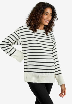 Crème kleurige pullover met zwarte horizontale strepen. Geribde boorden en zoom. Zachte, gestructureerde breiwerkstof. Losse pasvorm en ronde halslijn.