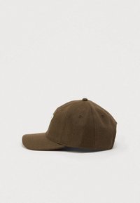 Brown wool cap with a curved brim, featuring a stitched graphic detail on the front. Soft texture with a rounded crown and ventilation holes.