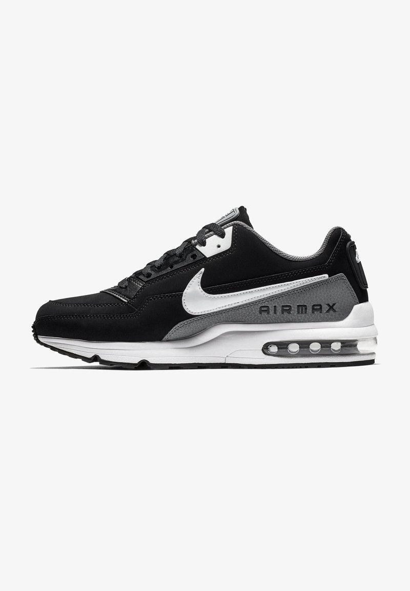 Sneaker Nike Air Max noir et gris avec une tige en suède et en mesh, accents blancs, unité Air visible et un panneau de talon texturé gris.