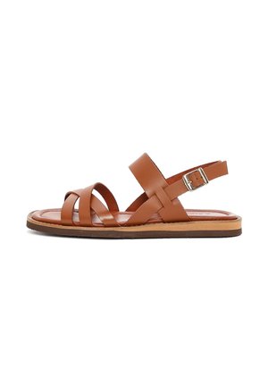 Brown leather flat sandals with crisscross straps, an adjustable ankle strap, and a flat sole with a natural wood finish.
