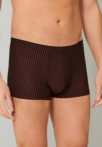 Black and dark red striped boxer shorts with a snug fit, elastic waistband, and a defined front pouch. Soft fabric with slight sheen.