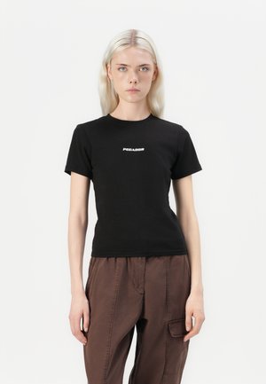 Black cotton t-shirt with short sleeves, featuring a white "PEGADOR" logo in the center. Fitted design, smooth texture, plain background.