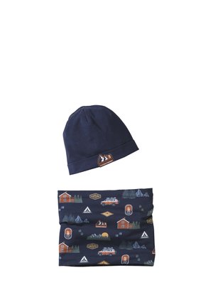 Navy blue beanie and neck gaiter with outdoor-themed prints including cabins, trucks, campfires, and mountain logos.