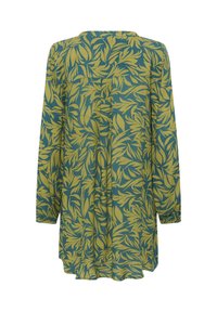 Tunique à manches longues en vert et jaune avec un motif de feuilles, offrant une coupe décontractée et un léger fronce à l'arrière pour un confort optimal.