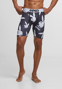 Boxer-briefs noirs avec un motif répétitif de logo de lapin blanc, dotés d'une taille blanche affichant le nom de la marque "PSD."