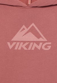 Ροζ αθλητική μπλούζα με λογότυπο βουνού και κείμενο "VIKING", και τα δύο σε πιο ανοιχτό τόνο, με λεία υφή σαν βαμβάκι.