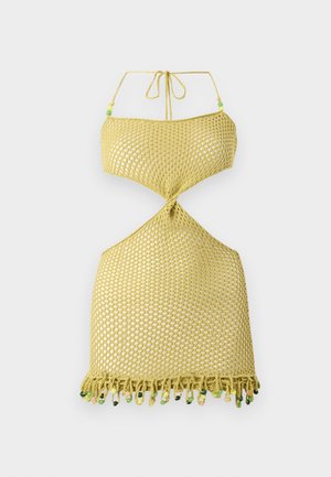 Yellow knitted dress with a halter neck, featuring a twisted design, open sides, and a fringed hem adorned with colorful beads.