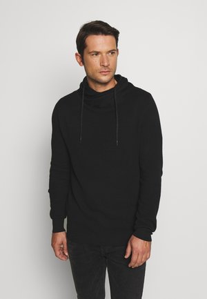 Sudadera de punto negra con cuello tipo cowl y cordones. Presenta mangas largas, puños acanalados y una tela texturizada.