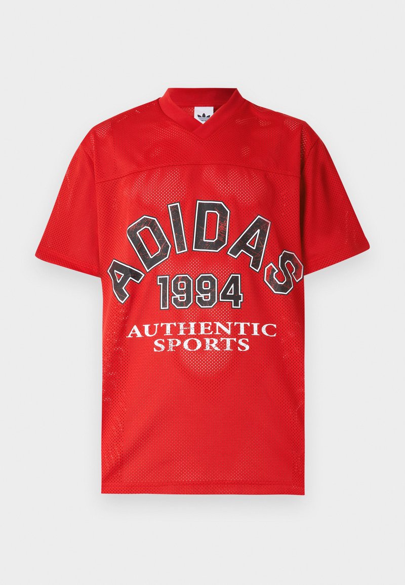Maillot de sport rouge perforé d'Adidas avec le texte "ADIDAS 1994 AUTHENTIC SPORTS" sur le devant et un col en V.