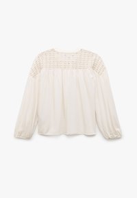 Blusa crema con maniche lunghe a sbuffo. Presenta un design in pizzo all'yoke e un corpo plissettato per una vestibilità ampia. Tessuto morbido al tatto.