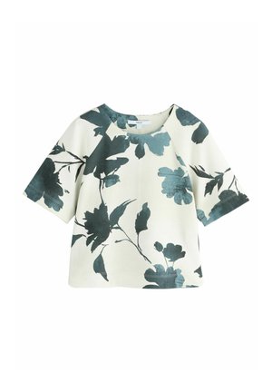 Bloemendruk top met korte mouwen, met groene en teal bladeren op een zachte beige achtergrond. Casual ontwerp met een ronde halslijn.