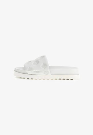 White slide sandals featuring a padded strap with embossed floral patterns and a textured white sole. Designed for casual wear.