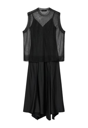 Musta hihaton mekko, jossa läpikuultava verkkomainen yläosa ja virtaviivainen epäsymmetrinen helma, ripustettuna valkoista taustaa vasten.