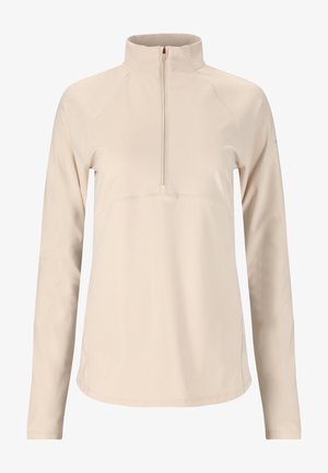 Beige pullover, jossa on korkea kaulus ja puolivetskari. Pitkät hihat, sileä pinta ja huomaamattomat ompeluyksityiskohdat etuosassa.