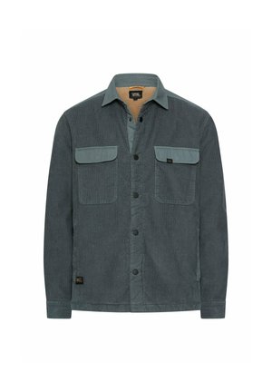 Dunkelgrüne Herren-Cordjacke mit zwei knöpfbaren Brusttaschen, durchgehender Knopfleiste und weichem beigen Innenkragen.