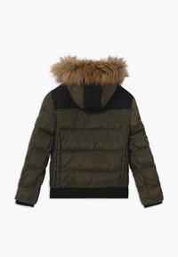 Dark olive puffer jacket with a detachable brown faux fur hood, black shoulder panels, and ribbed black cuffs and hem. Features horizontal quilting.