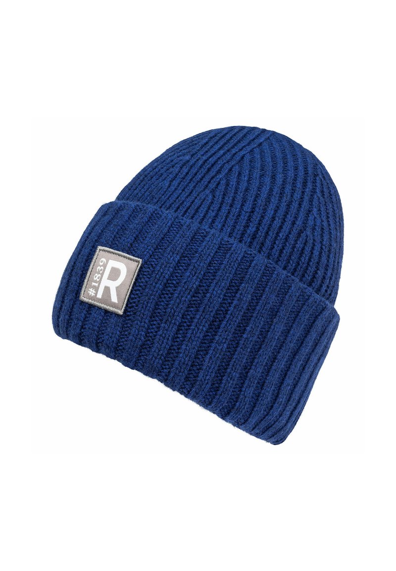 Knitted blue beanie hat with a ribbed texture, featuring a folded cuff and a rectangular gray patch with a white "R" logo.