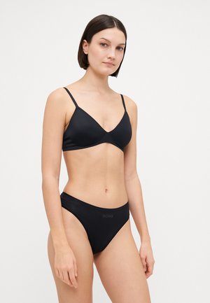 Black bikini set featuring a minimalist triangular bralette and low-rise, seamless bottoms, made from smooth fabric with subtle branding.