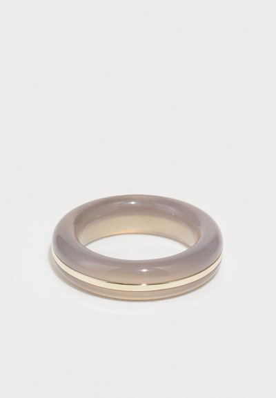 Translucent grå-brun harpiksring med en glat overflade, prydet med et smalt guldbånd, der fremhæver midten. Rund form, ensartet tekstur.