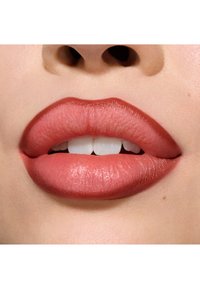 Full lips in a soft, nude pink shade with a smooth texture and subtle shine, showing even color and a natural appearance against the skin.