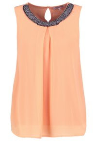 Persikofärgad utanärmad blus i lättviktsmaterial, med en svart dekorerad halsringning och en plisserad frontdesign. Nyckelhål på baksidan.