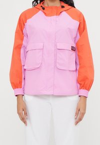 Color-blocked jacket with pink body and orange sleeves, featuring two front pockets, elastic cuffs, and a drawstring hood.
