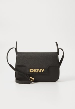 Black DKNY crossbody bag made from textured material with a gold logo, flap closure, and adjustable strap. Minimalist rectangular shape.