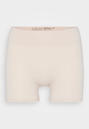 Beige strikkede shorts med bred, elastisk midje. Glatt tekstur og tettsittende design uten synlige sømmer eller mønstre.