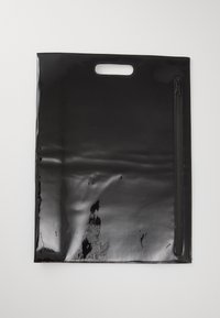Schwarze Plastiktasche mit glänzender Oberfläche, ausgestattet mit einem oberen Griff und einer seitlichen Reißverschlusstasche. Glatte Textur mit leichten Kratzern sichtbar.