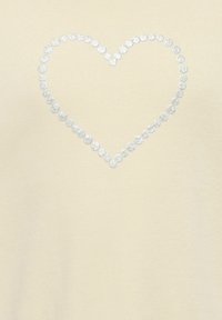 Felpa beige chiaro con un motivo a cuore argentato scintillante realizzato con decorazioni rotonde sulla parte anteriore.