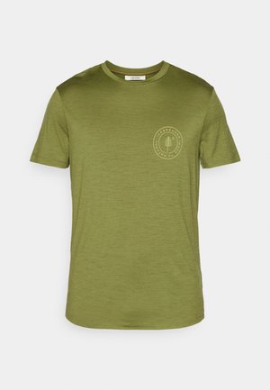 Olive green T-shirt made of soft fabric, featuring a round neckline and short sleeves. Includes a small circular logo on the left chest.