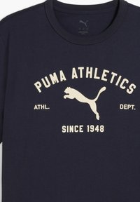 Navy cotton T-shirt with a round neckline and short sleeves. Features white printed text "PUMA ATHLETICS" and a logo of a leaping cat.