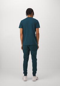 Björn Borg CENTRE TAPERED PANTS - Pantalones deportivos - reflecting pond
