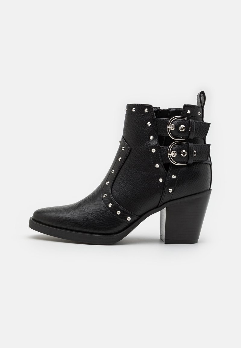 Black ankle boots with a pointed toe, featuring a textured leather material, silver studs, and two buckle accents on the side.
