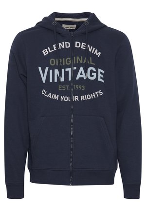 Navy Zip-Hoodie aus weichem Material. Mit einer Kordelzugkapuze, Fronttaschen und grafischem Text: "BLEND DENIM ORIGINAL VINTAGE" in kontrastierenden Farben.