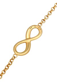 Bracciale d'oro con un simbolo dell'infinito come pezzo centrale e un design a catena. Contrassegnato con "Ag" e "925" per la qualità dell'argento. Texture liscia.